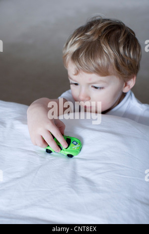 Little boy playing with toy car Stock Photo