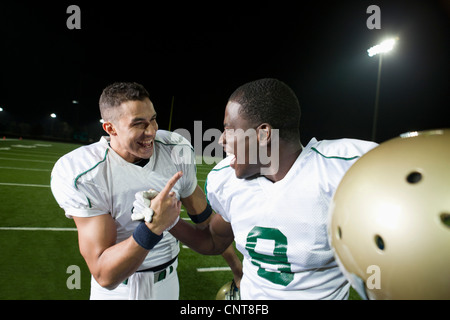 Football players celebrating victory together Stock Photo