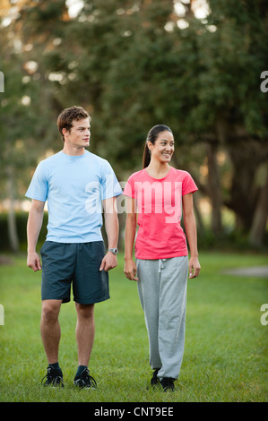 Young couple walking in park Stock Photo