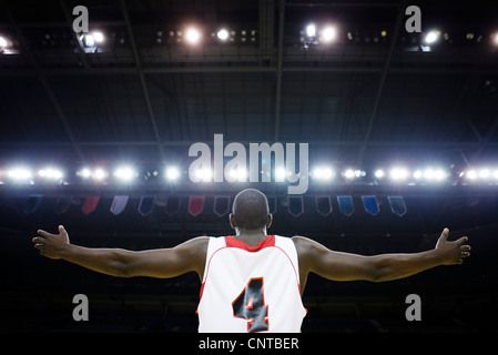 Basketball player with arms outstretched, rear view Stock Photo