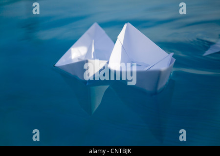 Paper boat floating on water Stock Photo