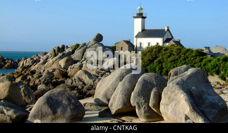 Lighthouse on the coast between rocks in Finistere in Brittany in France, France, Brittany Stock Photo