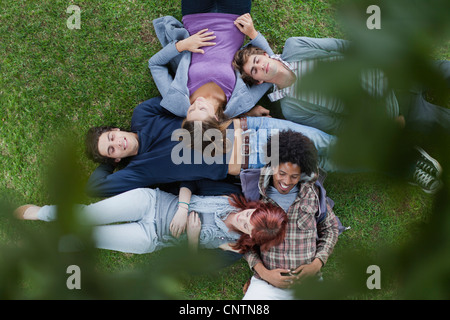 Students laying in grass on campus Stock Photo