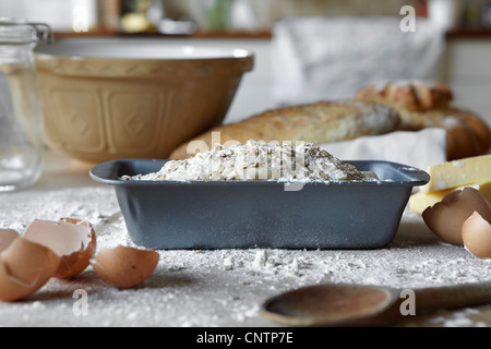 Bread loaves and dough in messy kitchen Stock Photo