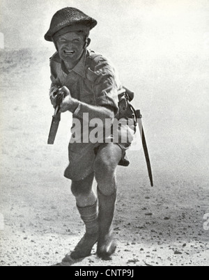 NORTH AFRICA CAMPAIGN 1942 A British soldier charges the camera in a posed propaganda photo Stock Photo