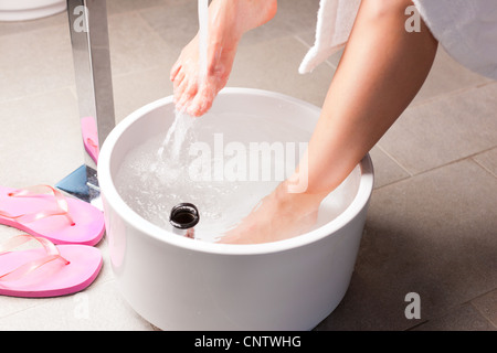 Woman having hydrotherapy water footbath in spa setting Stock Photo