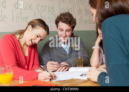 Students studying together in cafe Stock Photo