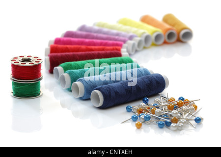 Multi coloured cotton thread reel spools in a sewing box draw for clothing  repairs Stock Photo - Alamy