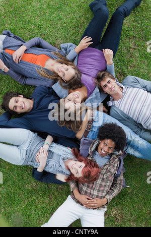Students laying in grass on campus Stock Photo