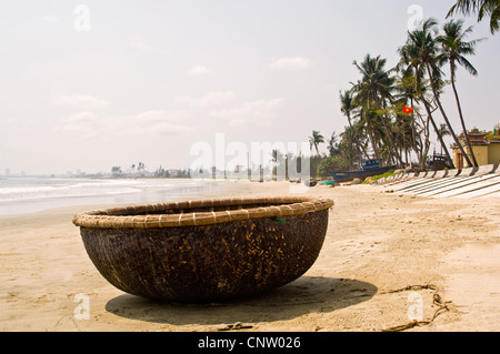 Horizontal close up of a traditional circular fishing or coracle, on the beach at Da Nang in Vietnam on a sunny day Stock Photo
