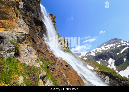 side view on waterfall in front of mountain panorama, Austria, Hohe Tauern National Park Stock Photo