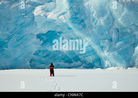 person in front of ice wall of the Emmanuel Glacier, Greenland, Ostgroenland, Tunu, Kalaallit Nunaat, Liverpool Land Stock Photo