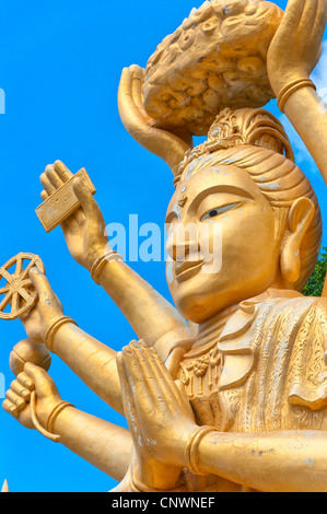 A huge statue of a multi armed buddha sits on a hill near to the city of Hua Hin in Thailand. Stock Photo