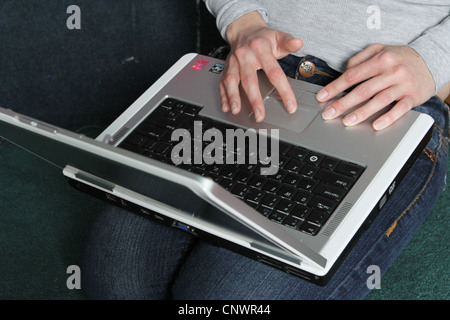 A close up of a person's hands on a laptop. Stock Photo