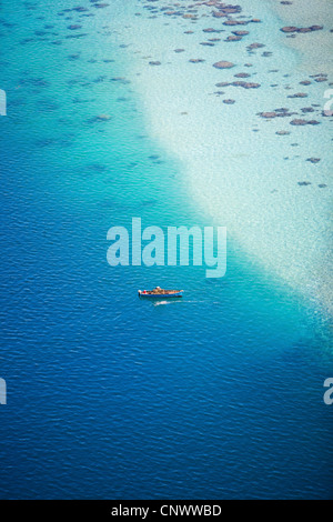 Small boat in turquoise waters if Indian ocean, Maldives, Indian Ocean Stock Photo