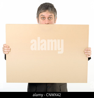 Astonished Staring Adult Man Behind Banner Isolated on White Background Stock Photo
