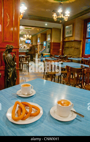 Coffee with churros for two. Madrid, Spain. Stock Photo