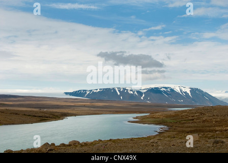 view over vast scant plain with glacier lake, mountain range and glacier Langjoekull in the bachground, Iceland Stock Photo
