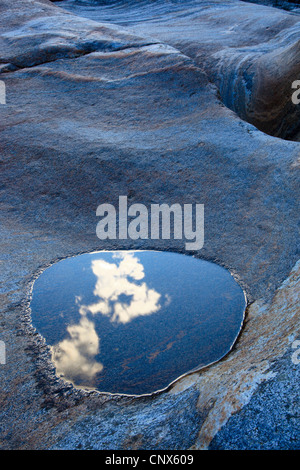 puddle with reflection of the sky in a rock in the river Verzasca running through the Valle Verzasca, Switzerland, Ticino, Verzascatal Stock Photo