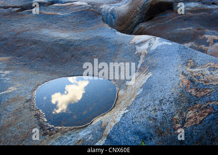 puddle with reflection of the sky in a rock in the river Verzasca running through the Valle Verzasca, Switzerland, Ticino, Verzascatal Stock Photo