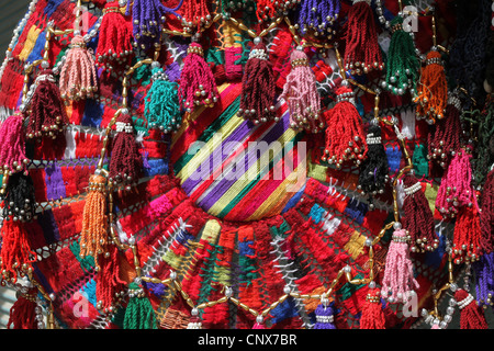 Multicolored handmade carpet (or dream catcher) displayed in a souvenir shop in Amman, Jordan. Stock Photo
