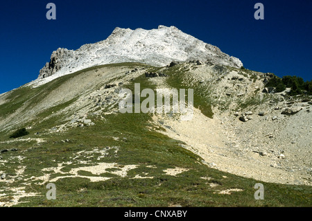 Scenic hike along the Kindersley Sinclair Pass. Bald face mountain peak with rock scree slopes Stock Photo