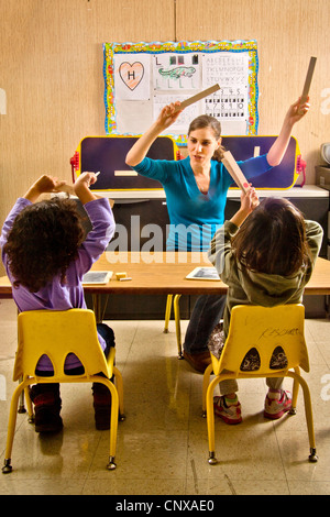 The teacher in a special needs pre-Braille writing class at the Blind Children's Learning Center starts the tapping song. Stock Photo