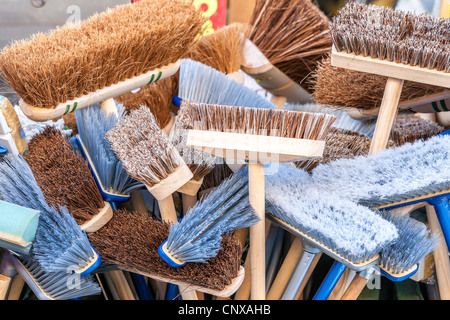 New brooms sweep clean. A lot of different new brooms in a big bunch for sale outside a shop. A new broom Stock Photo