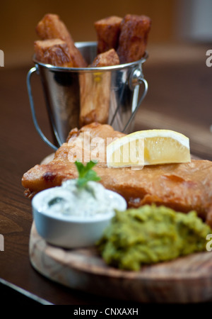 Picture by Darren Cool  Fish and Chips with mushy peas and tartar sauce, served in pub Hove Place, Hove, Sussex, UK Stock Photo