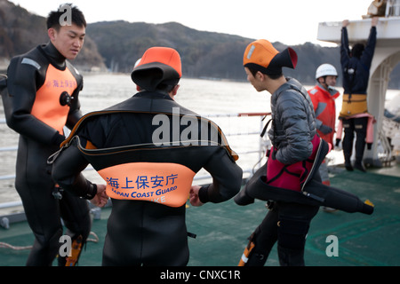 Japanese coast guard search underwater for the bodies of victims of the March2011 tsunami, in Kesennuma harbour, Tohoku, Japan. Stock Photo