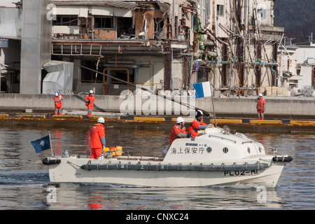 Japanese coast guard search underwater for the bodies of victims of the March2011 tsunami, in Kesennuma harbour, Tohoku, Japan. Stock Photo