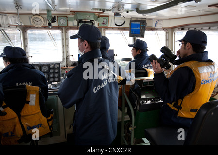 Japanese coast guard search underwater for the bodies of victims of the March2011 tsunami, in Kesennuma harbour, Tohoku, Japan. Stock Photo