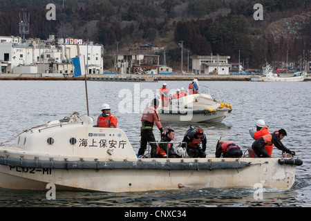 Japanese coast guard search underwater for the bodies of victims of the March2011 tsunami, in Kesennuma harbour, Tohoku, Japan. Stock Photo