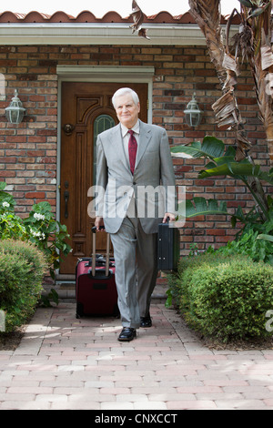 A businessman leaving his home on a business trip Stock Photo