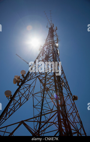 Sun shining down on a communications tower Stock Photo