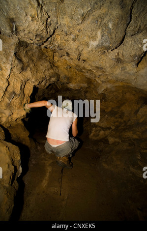 young biologist examining a cave, Italy, Tuscany Stock Photo