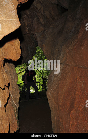 caver at the entrance of a grotto, Italy, Liguria, La Spezia Stock Photo