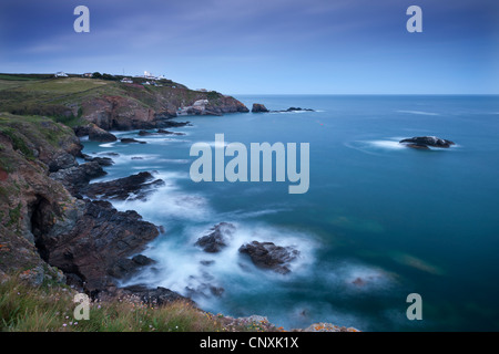 View from Lizard Point over rocky Polpeor Cove and onto the Lizard Lighthouse and old lifeboat Station, Lizard, Cornwall Stock Photo