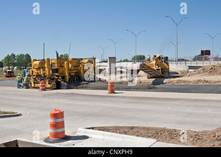 Streets are constructed by using a fluid concrete mix as workers hurry in making final touches before the concrete sets up. Stock Photo