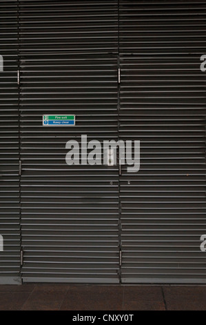 London Bridge , Southbank , The Queens Walk , slatted emergency office fire exit door pattern horizontal lines & with signs Stock Photo