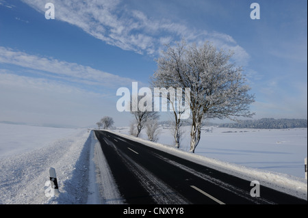 ploughed road through a snow-covered field landscape, Germany, Bavaria, Upper Palatinate Stock Photo