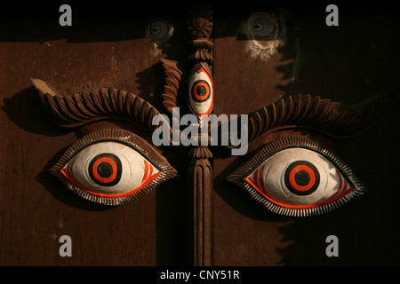 Buddha's Eyes. Woodcarving in a gate of a dwelling house in Bhaktapur, Nepal. Stock Photo