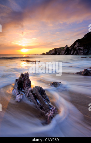 Surging waves break on the rocky shore at Westcombe Beach in South Devon, England. February 2009 Stock Photo