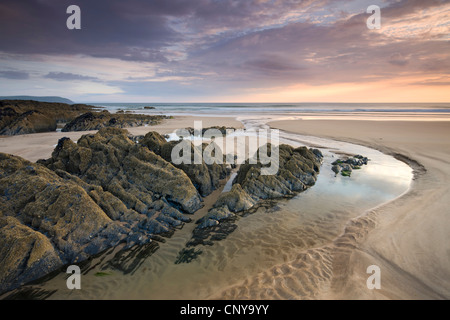 Sunset on the rocky and sandy beach at Combesgate, Woolacombe, Devon, England. Summer (June) 2010. Stock Photo