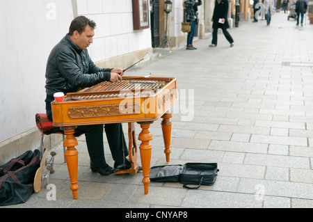 Busker playing the dulcimer in Market Square, Krakow, Poland. Stock Photo