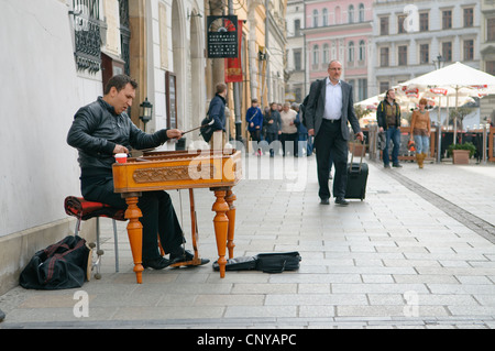 Busker playing the dulcimer in Market Square, Krakow, Poland. Stock Photo