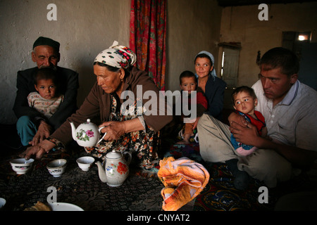 Tea drinking in a Kazakh family living in a kishlak beside the Uzbek-Turkmen border near Khiva, Uzbekistan. Stock Photo