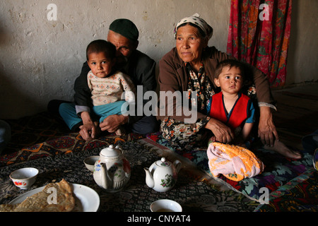 Tea drinking in a Kazakh family living in a kishlak beside the Uzbek-Turkmen border near Khiva, Uzbekistan. Stock Photo