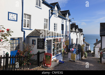 Local shop on steep narrow cobbled street in quaint picturesque village with view to the sea in Clovelly North Devon England UK Stock Photo