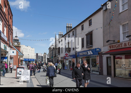 Street scene with people in the city centre shopping precinct. High Street, Bangor, Gwynedd, North Wales, UK. Stock Photo